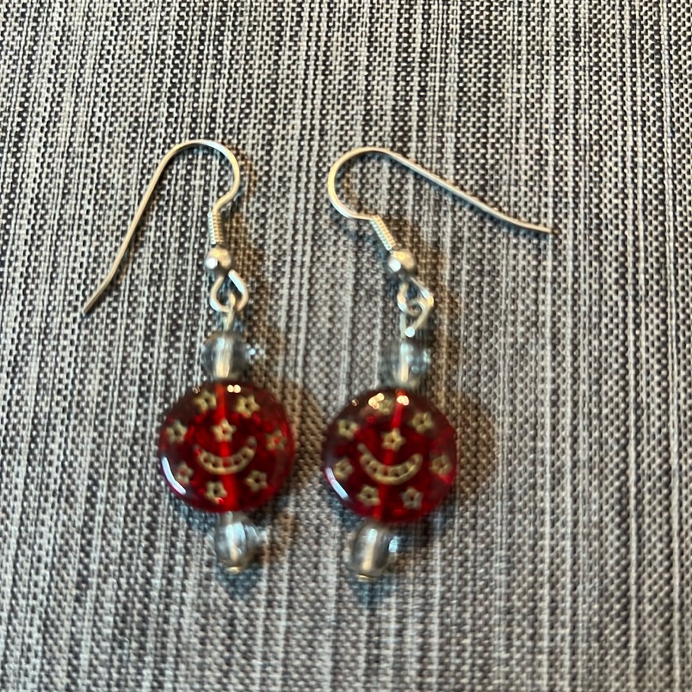 Red dangle earrings embossed with stars